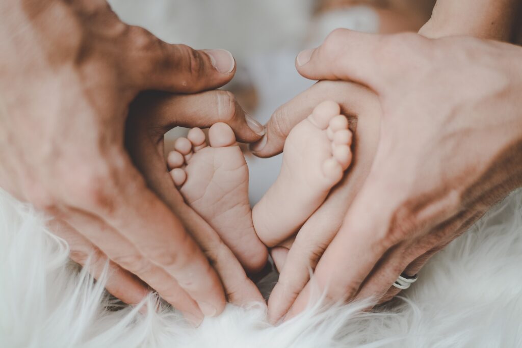 赤ちゃんの足に重ねる親の手